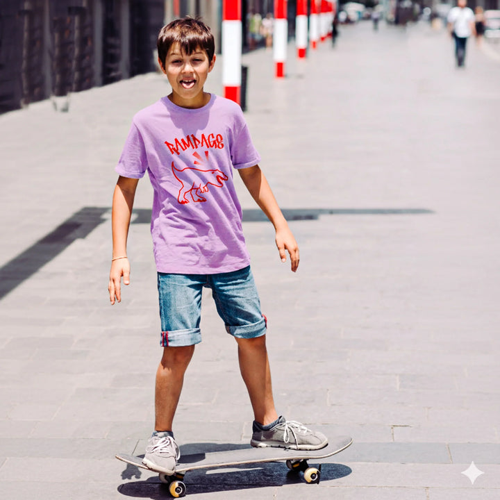 Child wearing a RAMPAGE house panther purple t-shirt with red graphics and text, standing on a skateboard outdoors