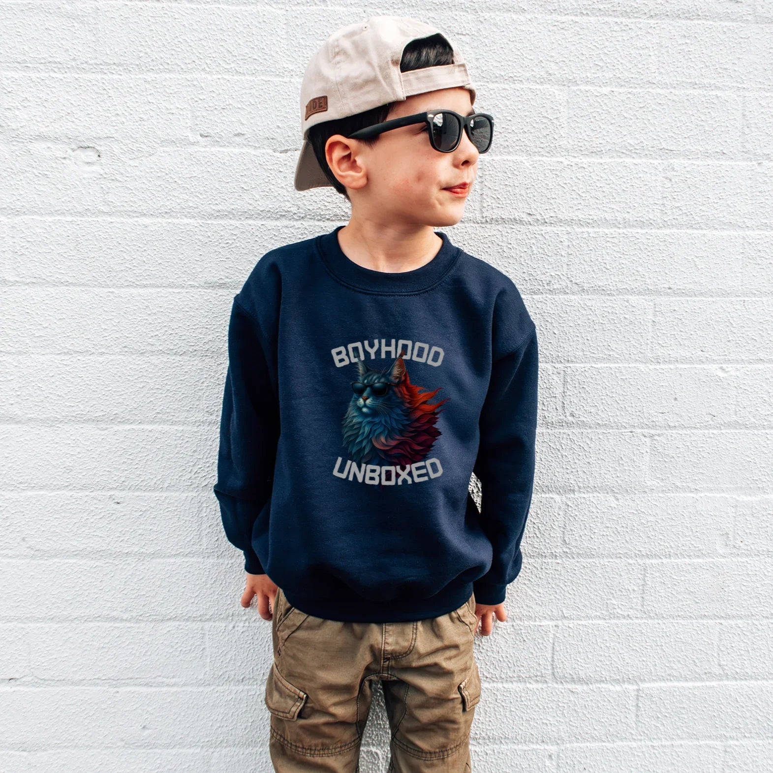Child wearing a navy boyhood, unboxed  House Panther sweatshirt with text and graphics, standing against a white brick wall.